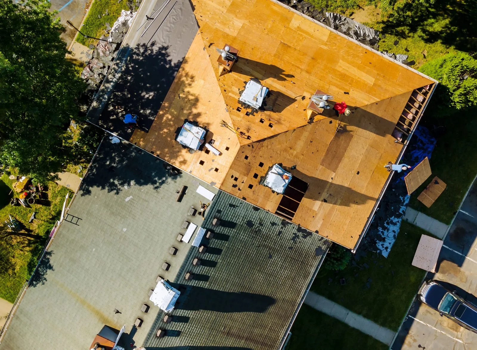 New shingles being laid on an apartment building roof
